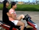 Cô gái Hà Nội đi xe máy bằng chân trong đô thị